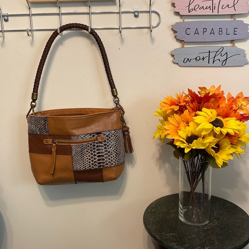 The SAK Handbag 100% Leather w/Braided Strap. Plenty of pockets. Gently Used.